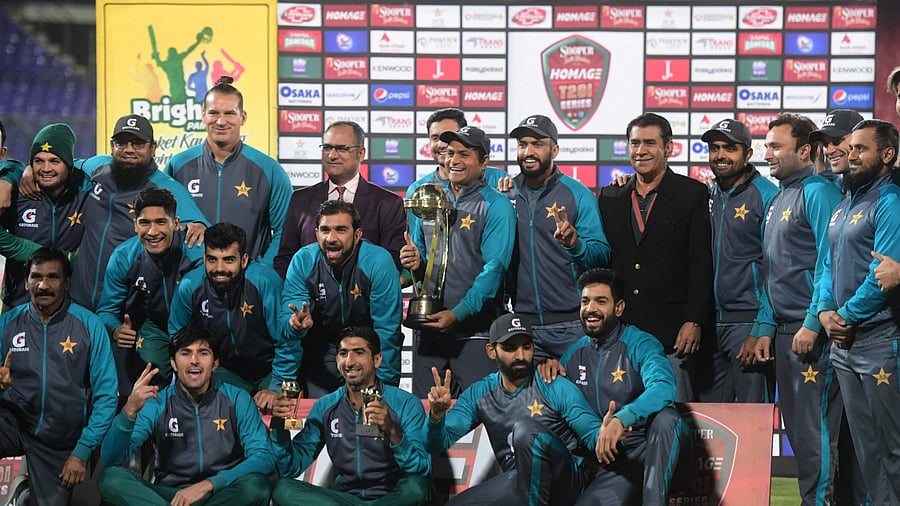 Pakistan's team members celebrate with the trophy after winning the series at the end of the third and final Twenty20 international cricket match against West Indies. Credit: AFP Photo