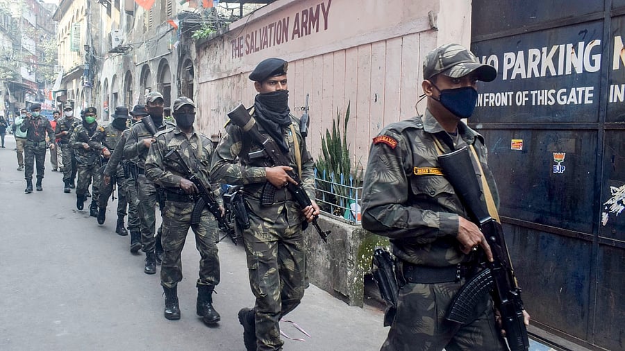 Police Combat Force patrol at a city street on the eve of the Kolkata Municipal Corporation elections, in Kolkata, Saturday. Credit: PTI Photo