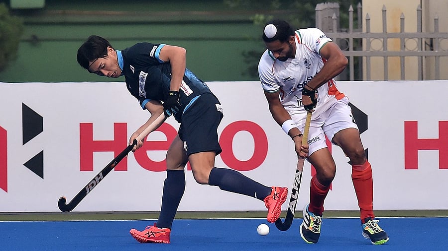 India's Akashdeep Singh (R) and Japan's Yoshiki Kirishita fight for the ball during the men's field hockey match between Japan and India at the Asian Championship Trophy tournament in Dhaka on December 19, 2021. Credit: AFP Photo
