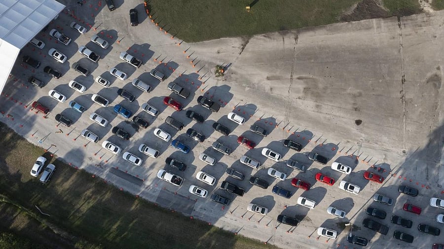 an aerial view, cars lineup at a drive-thru Covid-19 testing site at Tropical Park on December 20, 2021 in Miami, Florida. Credit: AFP Photo