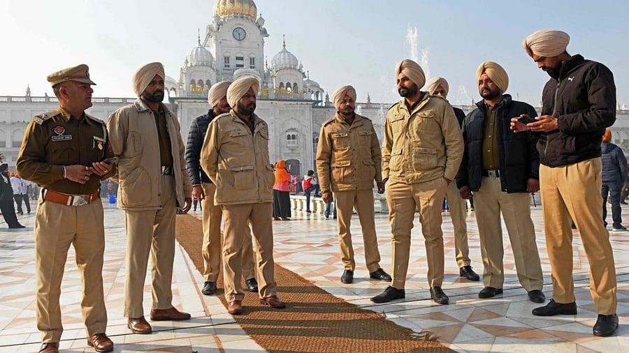 Policemen stand guard outside the Golden Temple in Amritsar on December 19, 2021, a day after a man was beaten to death for allegedly trying to commit an act of sacrilege at the holiest shrine of the Sikh faith. Credit: AFP Photo