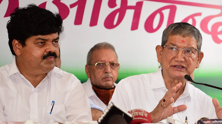 Former Uttarakhand chief minister Harish Rawat and Uttarakhand Congress President Ganesh Godiyal. Credit: PTI Photo
