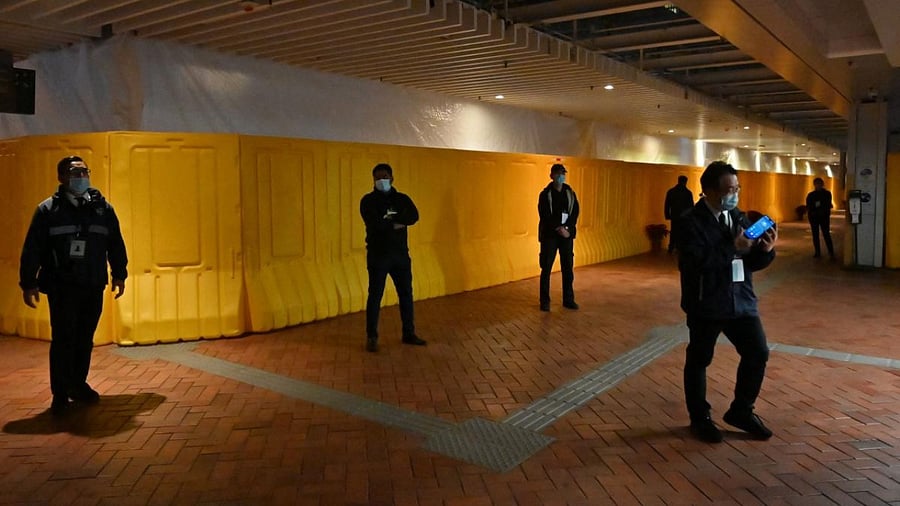 Security guard stand in front of barriers erected around the eight-metre (26-feet) high "Pillar of Shame" by Jens Galschiot mourning those killed in Beijing's Tiananmen Square at Hong Kong University in Hong Kong. Credit: AFP Photo