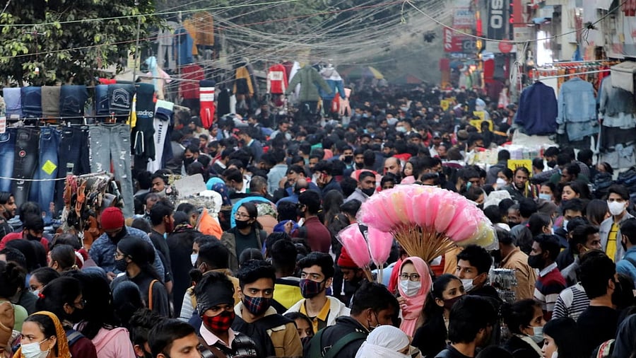 People shop at a crowded market ahead of Christmas during the ongoing coronavirus disease pandemic, in New Delhi. Credit: Reuters Photo