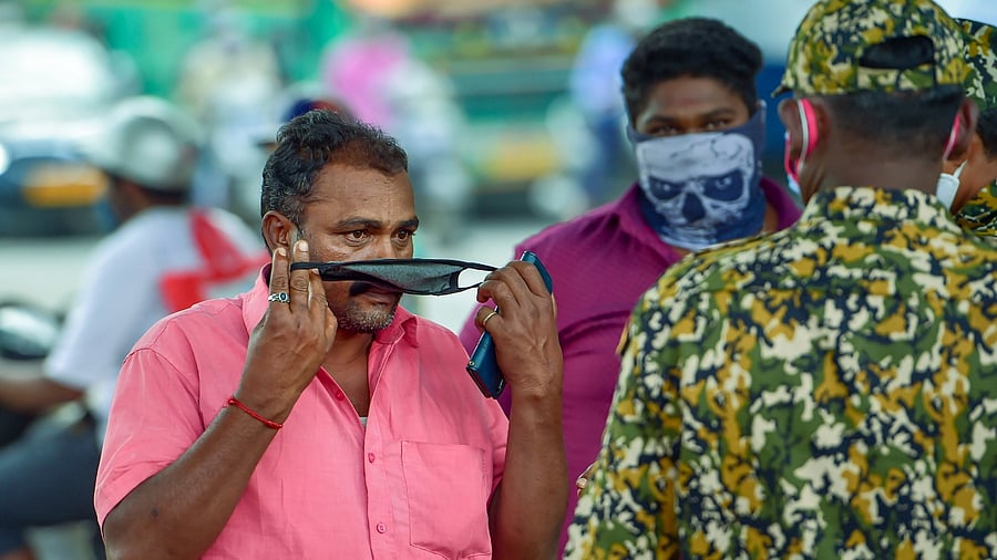 Bruhat Bengaluru Mahanagara Palike (BBMP) marshals ask citizens to wear a mask amid fear of spread of a new variant of Covid-19, in Bengaluru, Friday, December 3, 2021. Credit: PTI File Photo