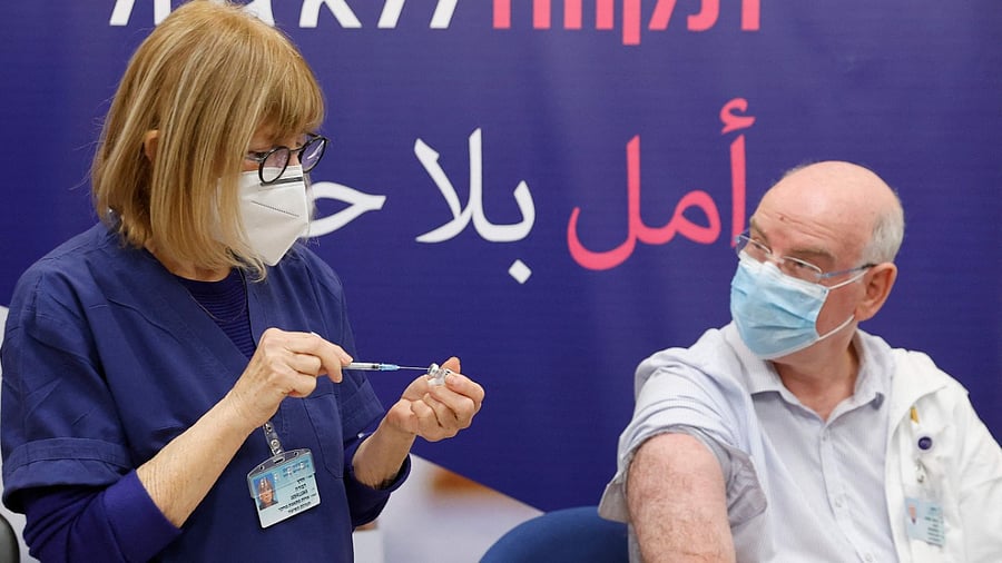 Israeli Professor Jacob Lavee receives a fourth dose of the Pfizer-BioNTech vaccine. Credit: AFP Photo