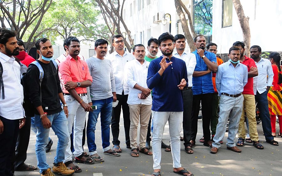 Candidates gather outside an exam centre following a language goof-up in the UGC-NET paper in Ballari on Sunday. Credit: DH Photo