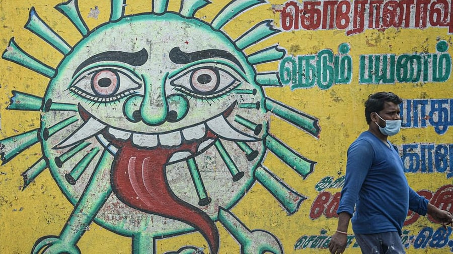 A man walks past a Covid-19 Coronavirus awareness mural in Chennai. Credit: AFP Photo