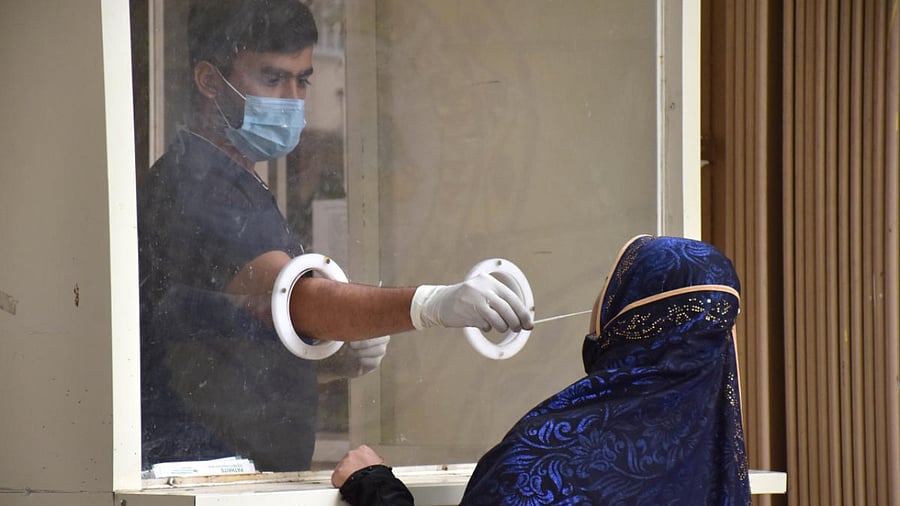 A health worker collecting swabs for Covid test in Bengaluru on Thursday. Credit: DH Photo /BK Janardhan
