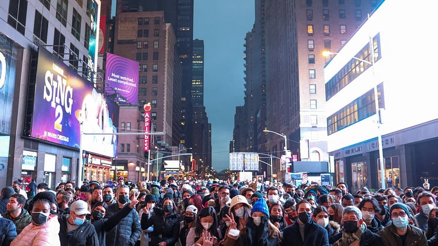 People gather before New Year's Eve celebrations begin in Times Square as the Omicron coronavirus variant continues to spread, in the Manhattan borough of New York City. Credit: Reuters Photo