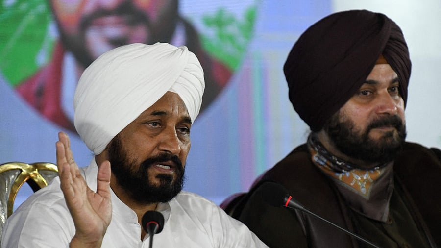 Punjab chief minister Charanjit Singh Channi (L) with Punjab Congress president Navjot Singh Sidhu. Credit: AFP Photo