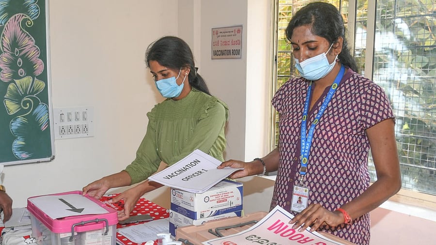 Health workers make preparations for vaccinating teenagers against Covid, at a school in Bengaluru on Sunday. The vaccination begins on Monday. Credit: DH Photo/S K Dinesh