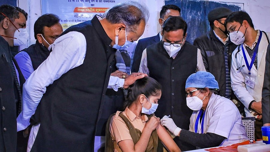 Rajasthan CM Ashok Gehlot supervises the administration of Covid-19 jab to a school student in Jaipur. Credit: PTI Photo