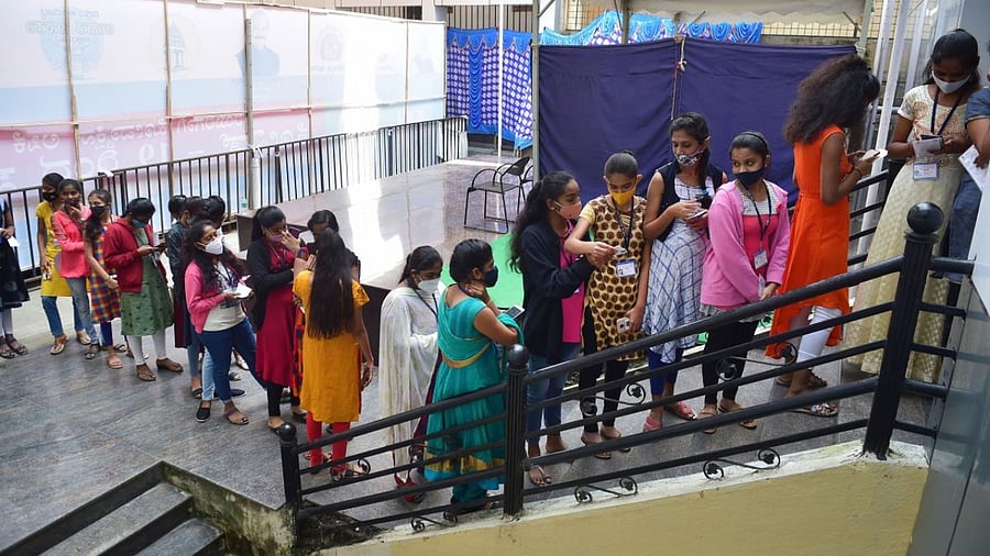 Teenagers stand in a queue to register for a dose of Covid-19 vaccine at a government school, amid fear of spread of Omicron, in Bengaluru. Credit: PTI Photo
