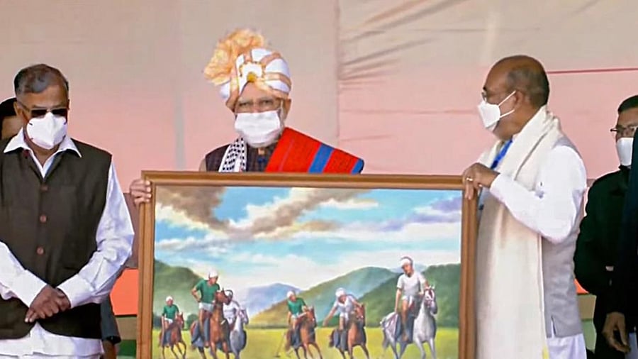 Prime Minister Narendra Modi receives a memento during inauguration and foundation stone laying of development projects in Manipur. Credit: YouTube/PTI Photo