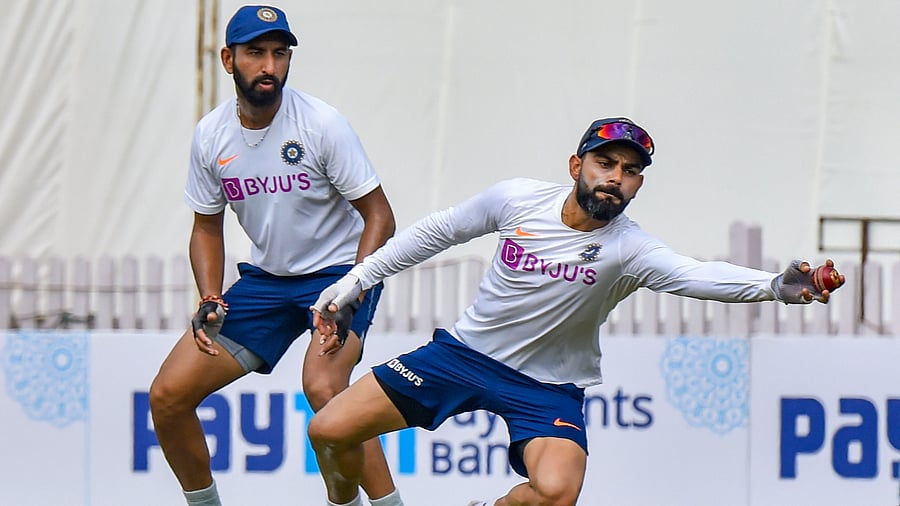 Indian cricket captain Virat Kohli and Cheteshwar Pujara. Credit: PTI Photo