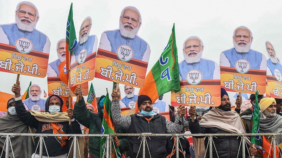 Bharatiya Janata Party (BJP) supporters hold BJP party flags and cut-outs with portrait of BJP leader and India's Prime Minister Narendra Modi during a rally ahead of the state assembly elections in Ferozepur on January 5, 2022 which was reportedly cancelled later citing security concerns. Credit: AFP Photo