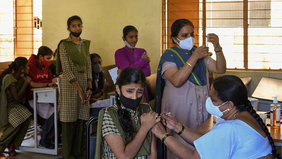 A student reacts as she receives a dose of the Covaxin vaccine against the Covid-19 coronavirus during a vaccination drive. Credit: AFP Photo