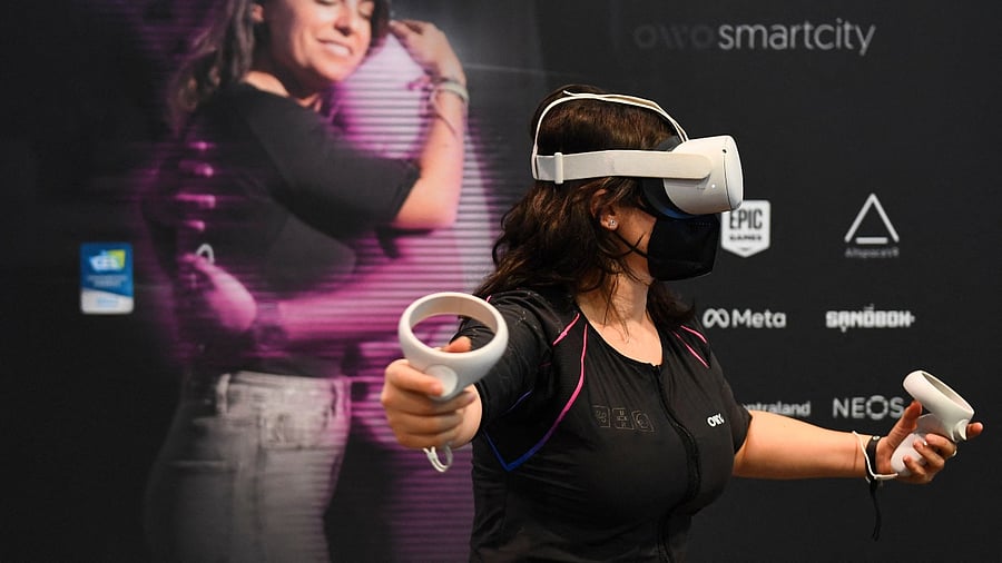 An attendee demonstrates the Owo vest. Credit: AFP Photo