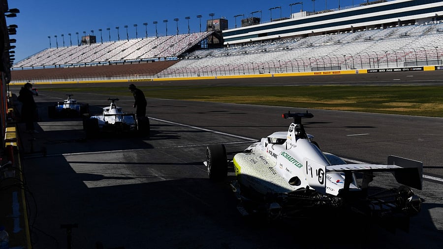 Autonomous race cars on pit row before the Indy Autonomous Challenge during the Consumer Electronics Show. Credit: AFP Photo