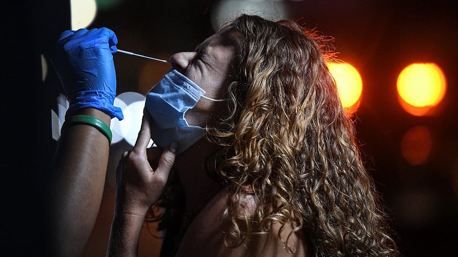 A health worker takes a swab sample from a tourist for a rapid antigen test amid the coronavirus disease. Credit: Reuters Photo