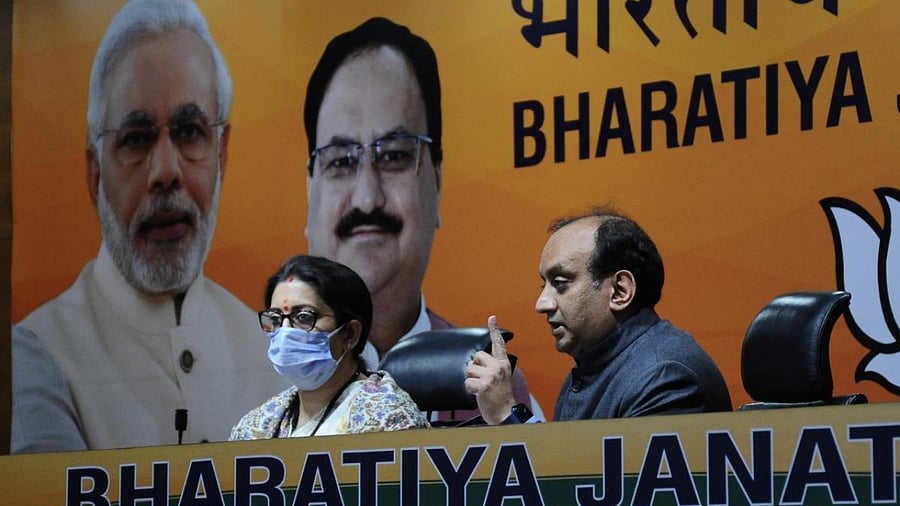 BJP leader Sudhanshu Trivedi seen along with Union Minister Smriti Irani. Credit: IANS Photo