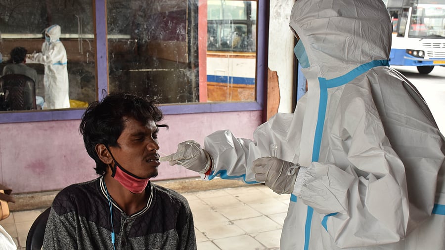 Swab tests to passengers arriving at the BMTC bus stand. Credit: DH Photo