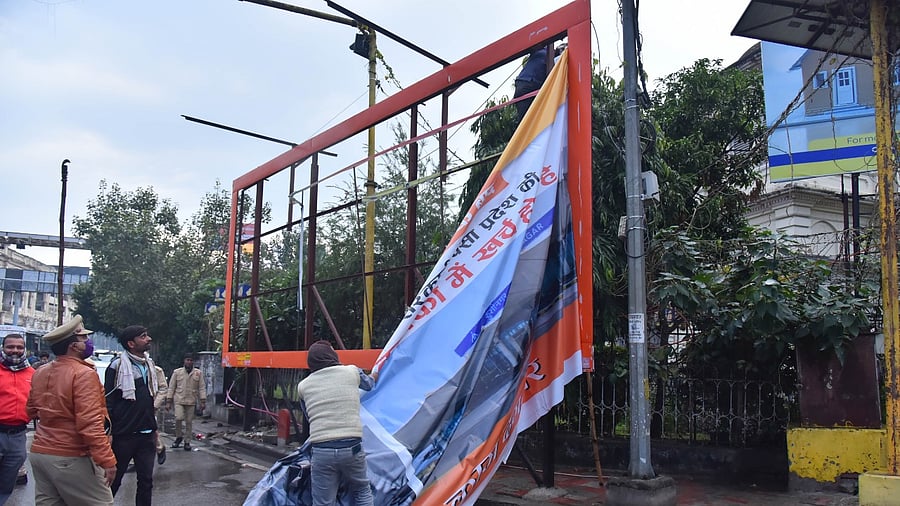 Authorities remove political posters in UP after the model code of conduct came into effect. Credit: PTI Photo