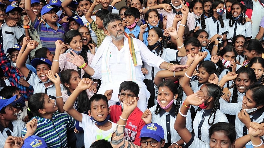 KPCC President DK Shivakumar with school children, during the 2nd day of the 10-day padayatra. Credit: IANS Photo