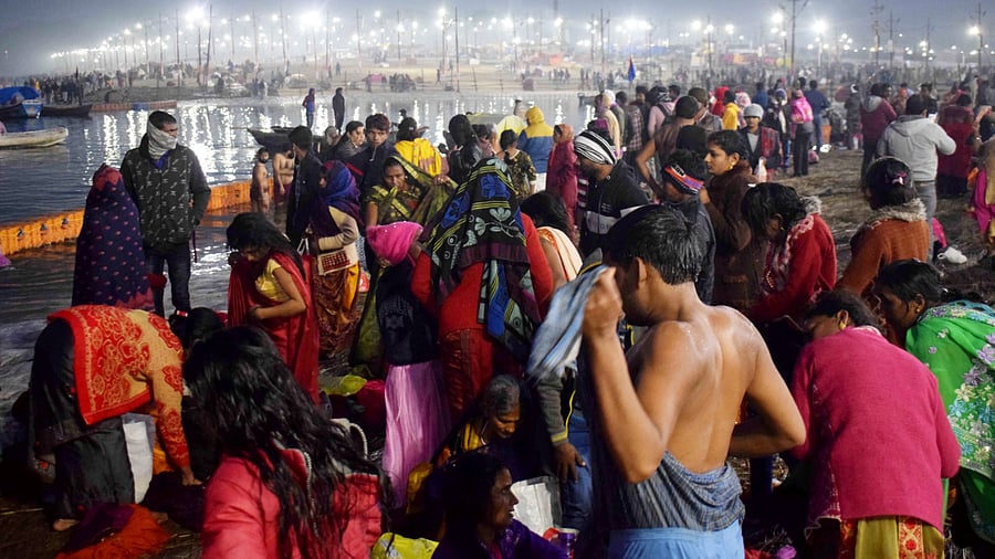 Devotees gather on the banks of Ganga river to take a 'holy dip' on the occasion of 'Makar Sankranti' during the ongoing 'Magh Mela' festival at Sangam. Credit: PTI Photo