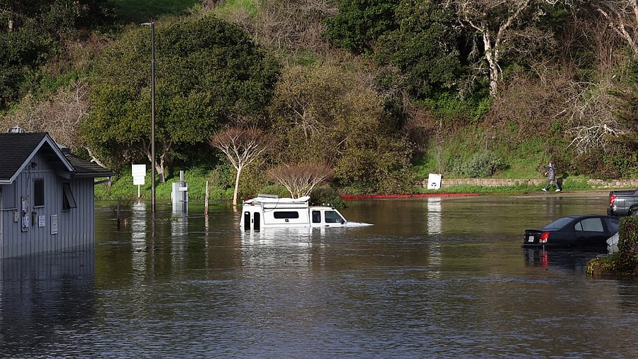 A damaged boat is partially submerged in a marina. Credit: AP Photo