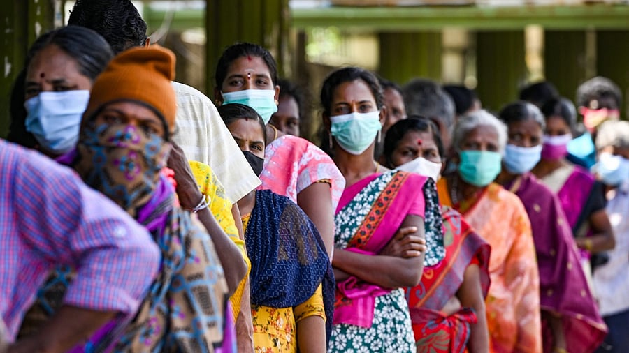 Needy stand in a queue to collect free food distributed by volunteers, during full lockdown imposed by Tamil Nadu government to curb the spread of Covid-19. Credit: PTI Photo