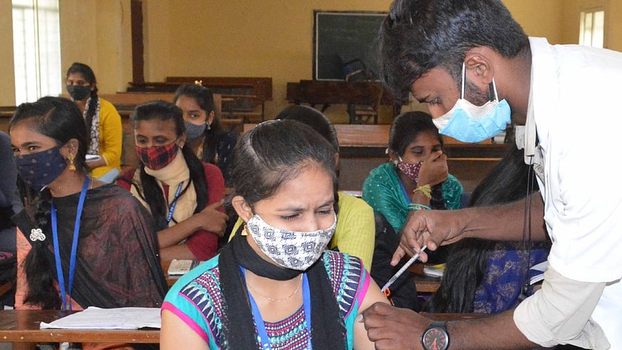 A health staff administers vaccine for Covid-19 to teens at a school in Bengaluru. Credit: IANS File Photo