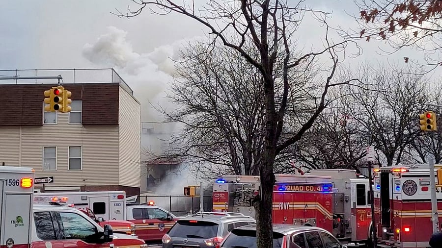 Emergency vehicles line the street as smoke raises following a fire and explosion at a building in New York City, New York, US, January 18, 2022, in this still image obtained from social media video. Credit: Reuters Photo