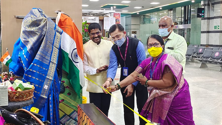 Dharmesh Mehta, terminal in-charge and Jyoti Naik, district officer, Khadi and Village Industries Board jointly inaugurated the khadi kiosk at Mangaluru International Airport. Credit: DH Special arrangement