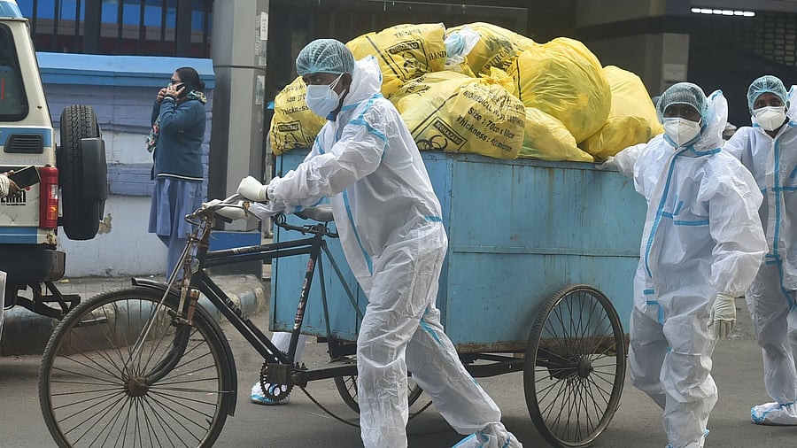 Health workers ferry Covid-19 waste from a medical facility. Credit: PTI Photo