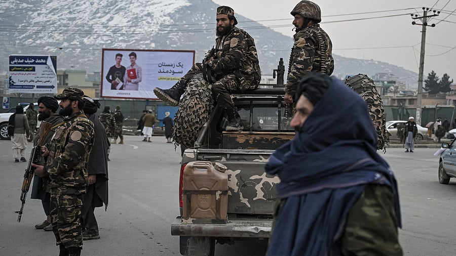Taliban fighters stand guard. Credit: AFP Photo