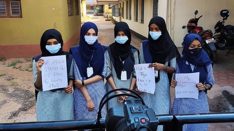 Five muslim girl students who have been prevented from attending classes with their `Hijab' (Head scard), staged a dharna near the college gate and head playcards declaring that wearing Hijab was their fundamental right. Credit: DH Photo