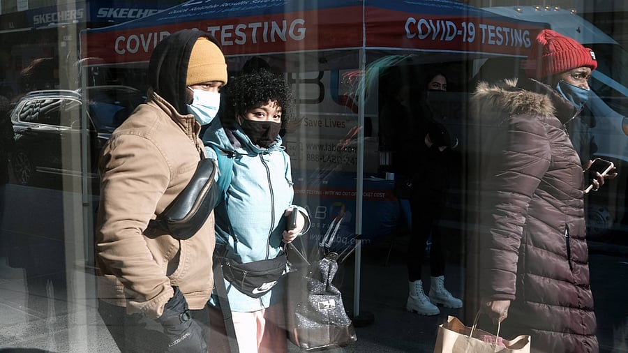 People pass Covid-19 testing van along a Manhattan street. Credit: AFP Photo