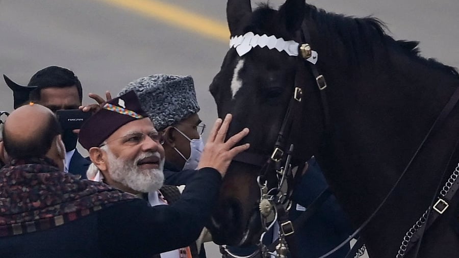 Indian Prime Minister Narendra Modi (2L) bids farewell to Virat, a horse from the President’s bodyguard that has participated on many Republic Day parades. Credit: AFP Photo