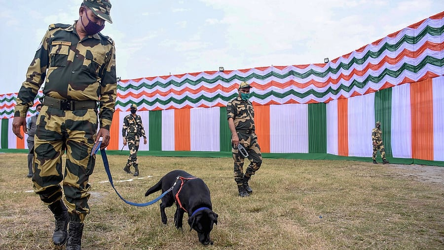 Security personnel with a sniffer dog check for explosives on the eve of Republic Day Parade 2022, in Guwahati. Credit: PTI Photo