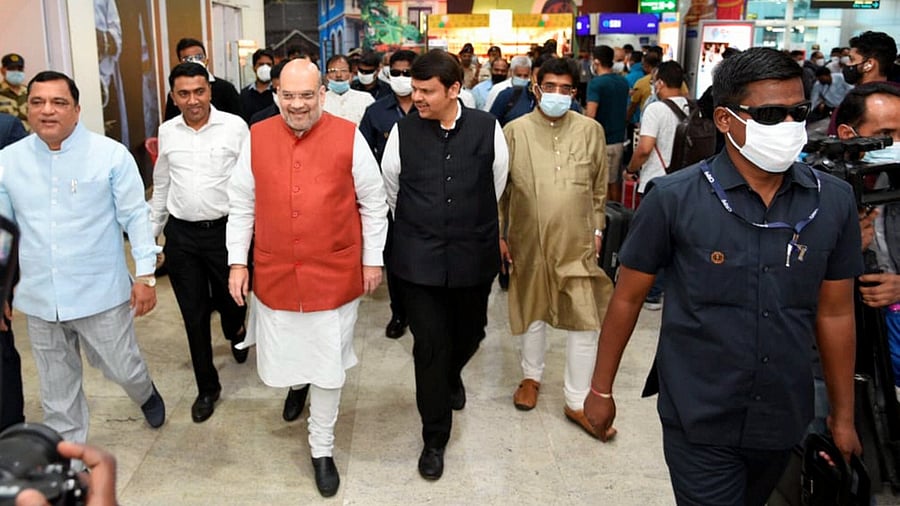 Union Home Minister Amit Shah arrives in Goa airport, ahead of campaigning for state assembly polls, in Dabolim, Sunday, January 30, 2022. Goa CM Pramod Sawant and BJP leader Devendra Fadnavis are also seen. Credit: PTI Photo