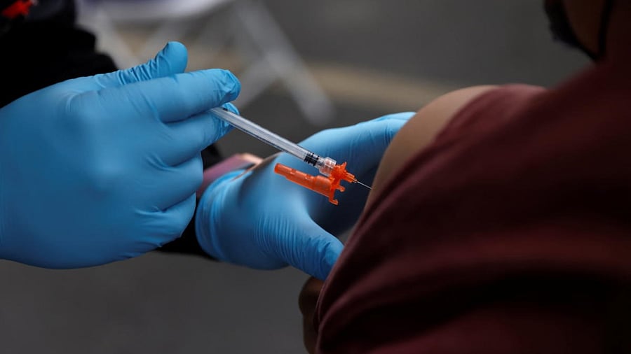 A health worker administers a dose of Pfizer Covid-19 vaccine. Credit: Reuters Photo