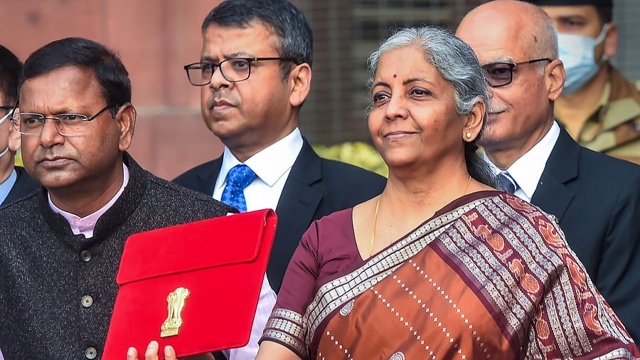 Union Finance Minister Nirmala Sitharaman holds a folder-case containing Budget 2022-23 as leaves from the Finance Ministry. Credit: PTI Photo