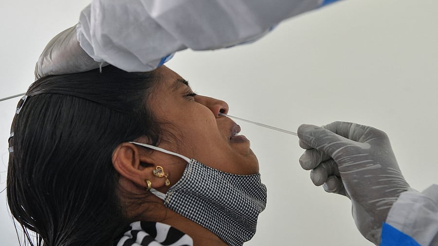 According to the new rates, a RT-PCR test will cost Rs 300 (old rate Rs 500)and Antigen test Rs 100(300). Credit: AFP Photo