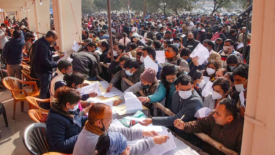 Polling officials at an election material distribution centre, a day before the Uttar Pradesh Assembly elections, in Noida. Credit: PTI Photo