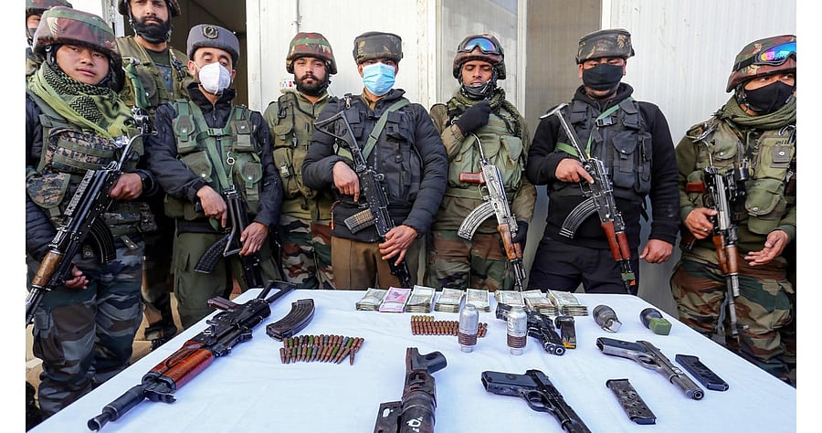 Security personnel display the arms and ammunition recovered from 4 Al-Badar militants arrested during a search operation, at Sopore in Baramulla district. Credit: PTI Photo