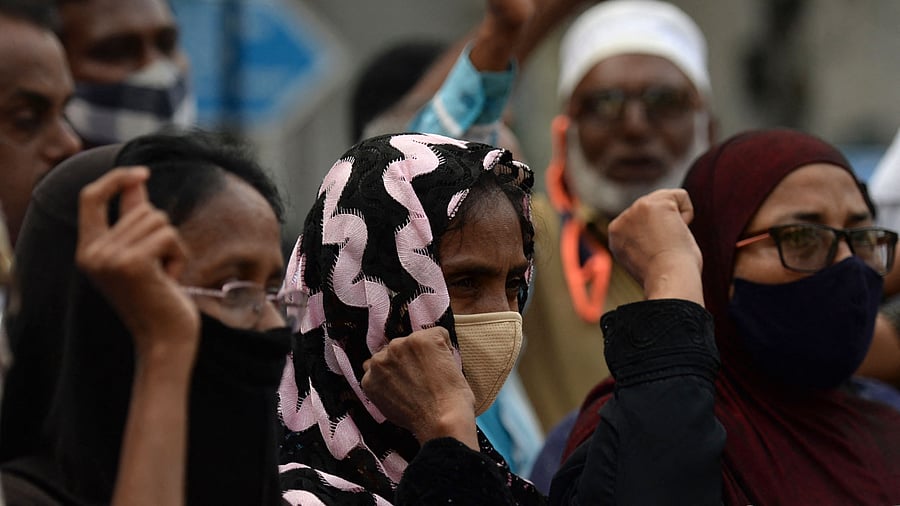 Muslim people take part in a demonstration to denounce the banning on Muslim girls wearing hijab to attend classes in few of Karnataka's educational institutes. Credit: AFP Photo
