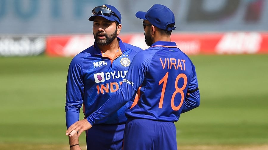 Rohit Sharma (L) and India's Virat Kohli interact. Credit: AFP Photo