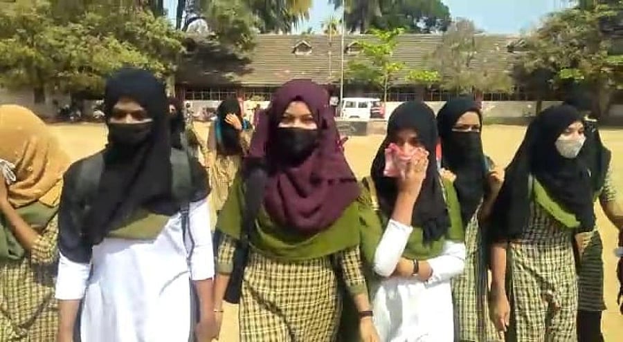 Videos of incidents where teachers and students were seen removing those attire outside school gates went viral. Credit: DH Photo